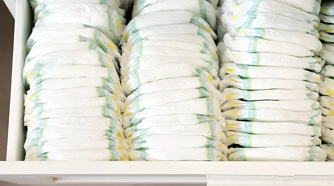 changing table drawer full of baby diapers