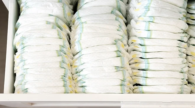 changing table drawer full of baby diapers