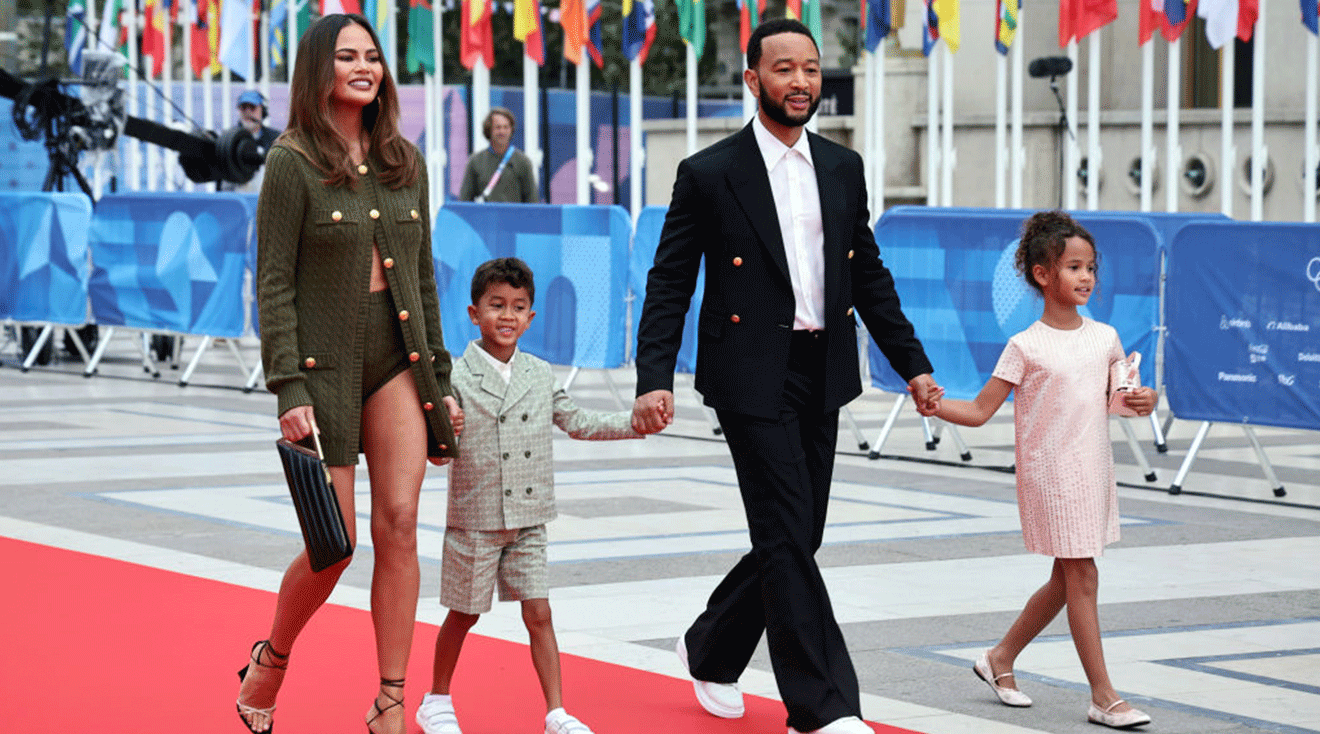 John Legend and his wife Chrissy Teigen with their two children arriving at the Trocadero ahead of the opening ceremony for the Paris 2024 Olympic Games