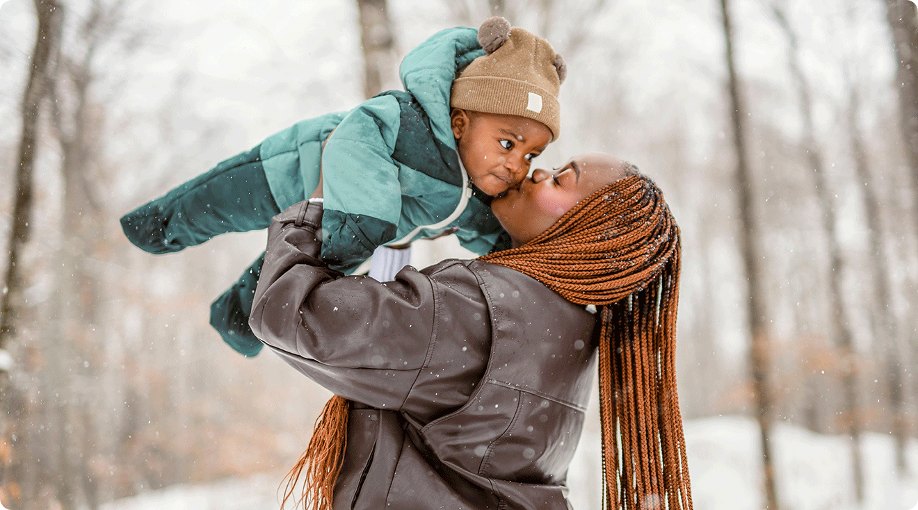 mom and baby outside in the snow during winter