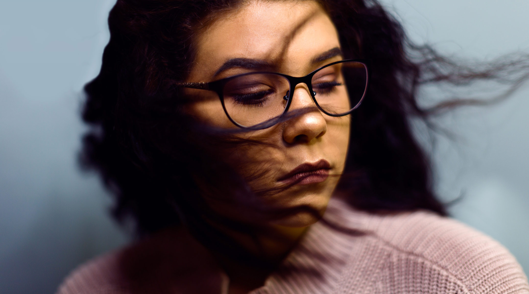 close-up of sad woman with glasses