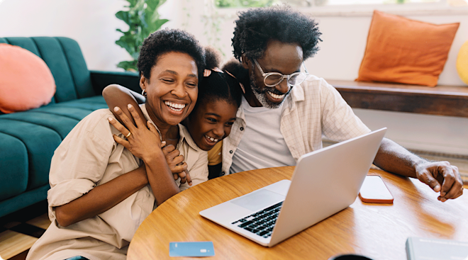 mom and dad shopping on laptop with daughter at home