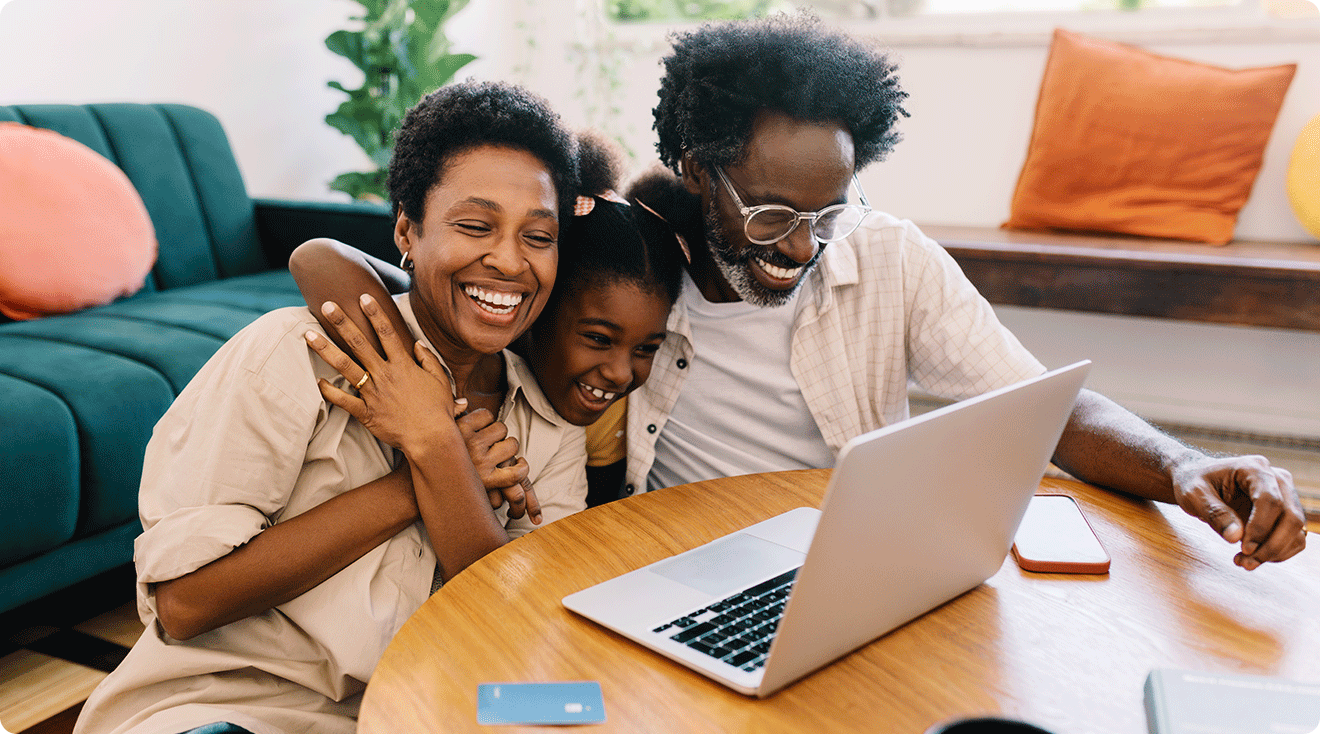 mom and dad shopping on laptop with daughter at home