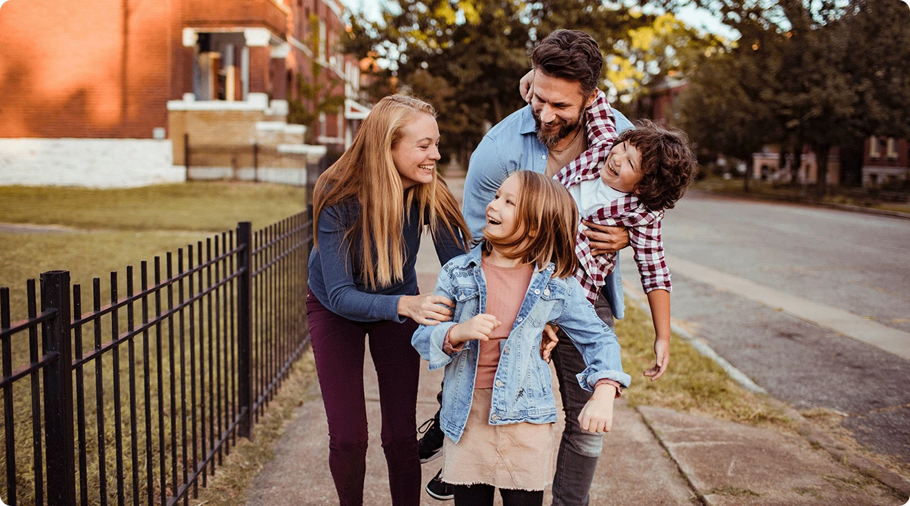 happy family walking in neighborhood