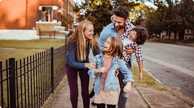 happy family walking in neighborhood
