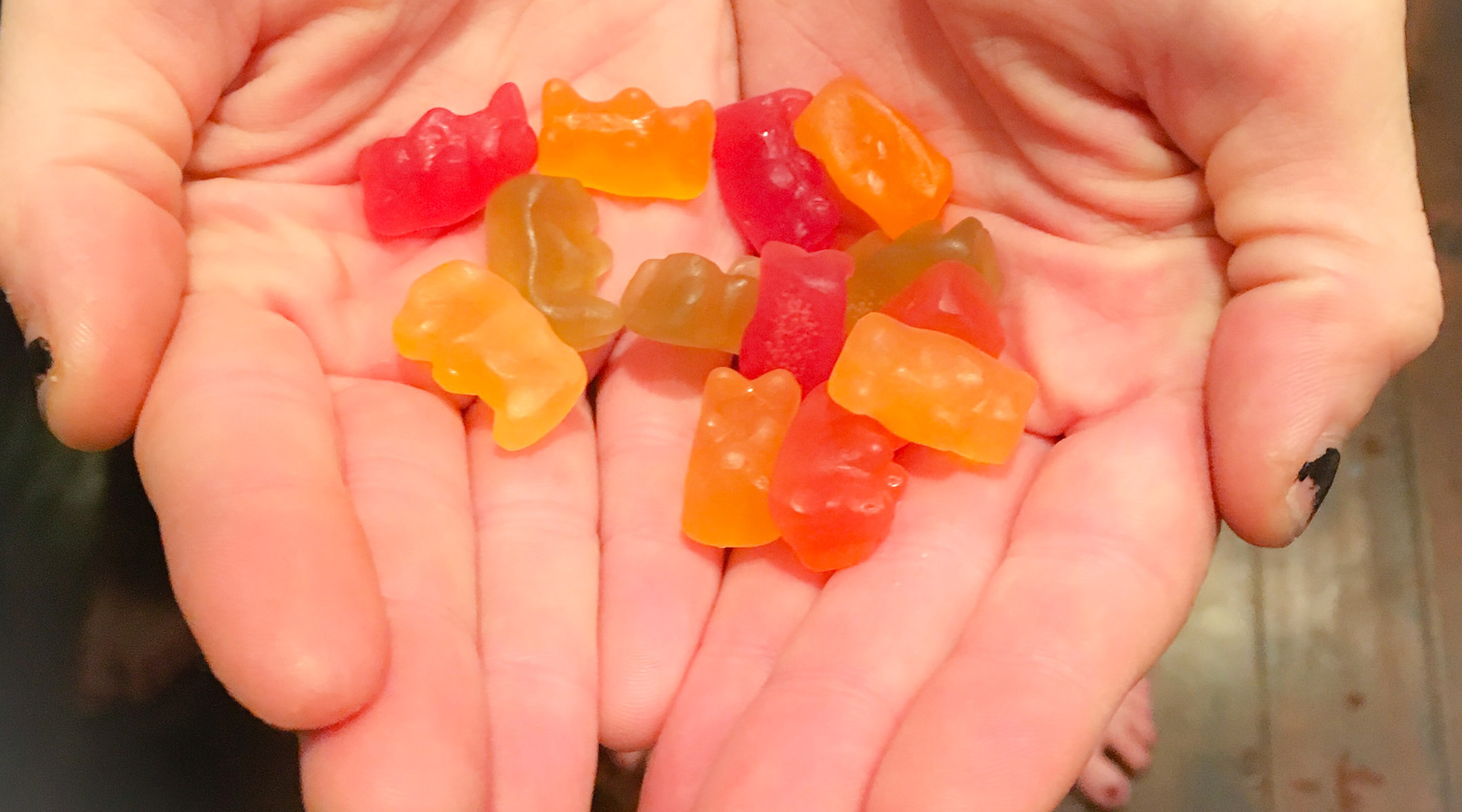 Kids holding gummy bears in hand; kids in Cleveland school given marijuana gummy bears. 