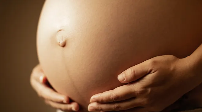 close up of bare pregnant belly