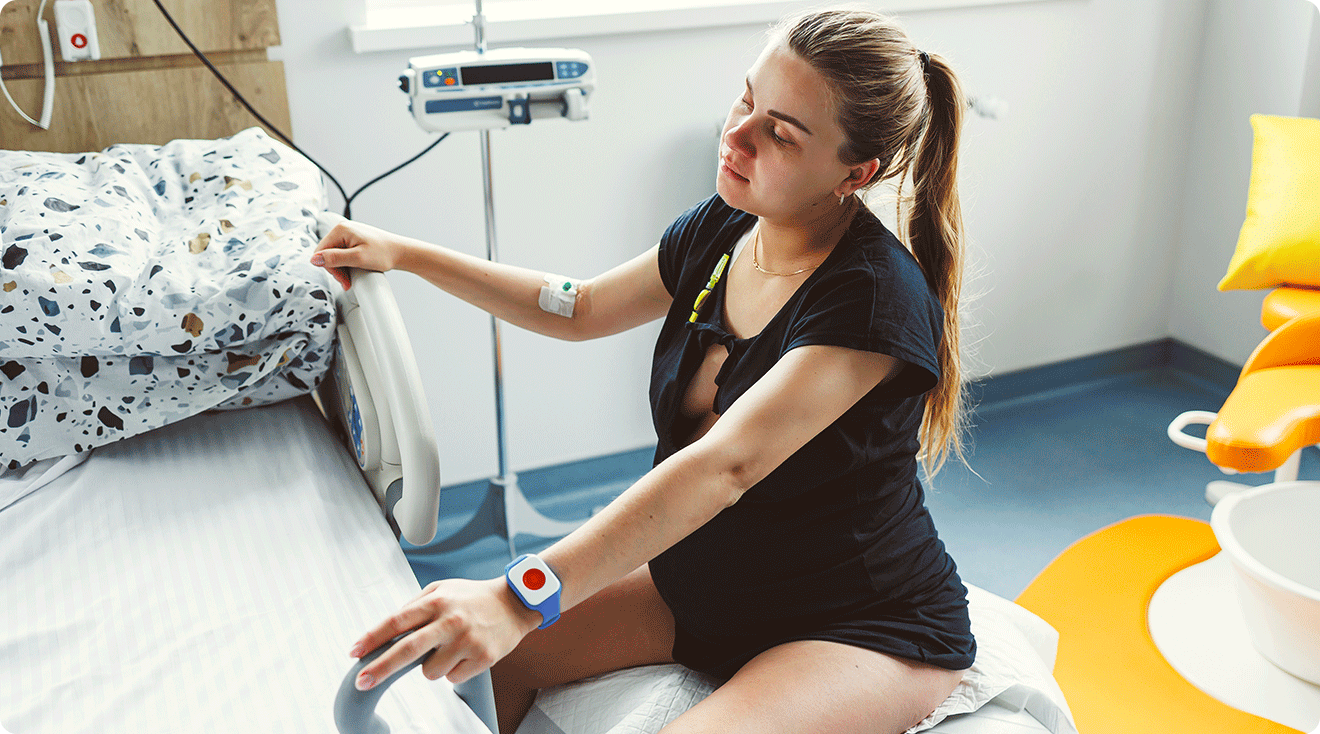 pregnant woman in labor sitting on exercise ball in hospital room