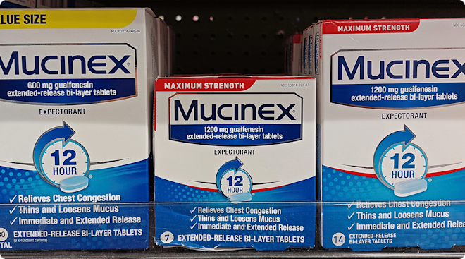 three packages of mucinex medicine in drugstore