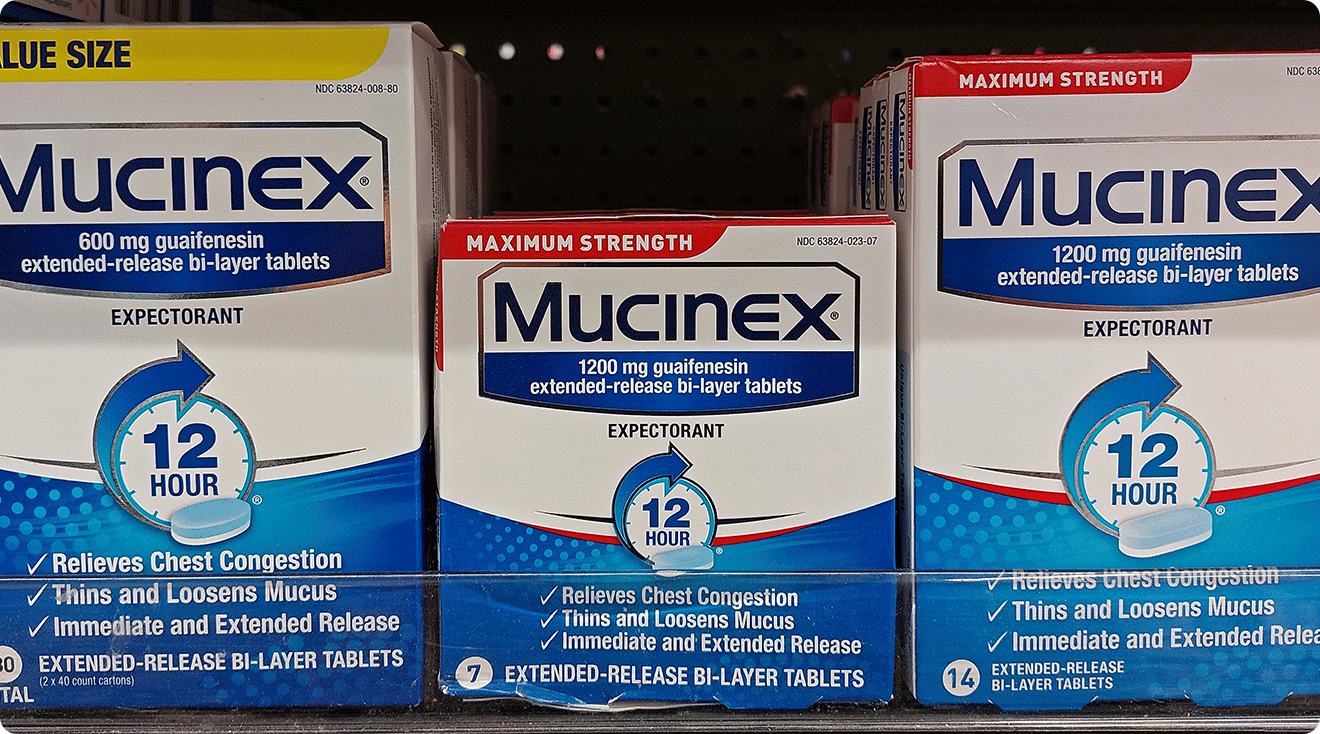 three packages of mucinex medicine in drugstore