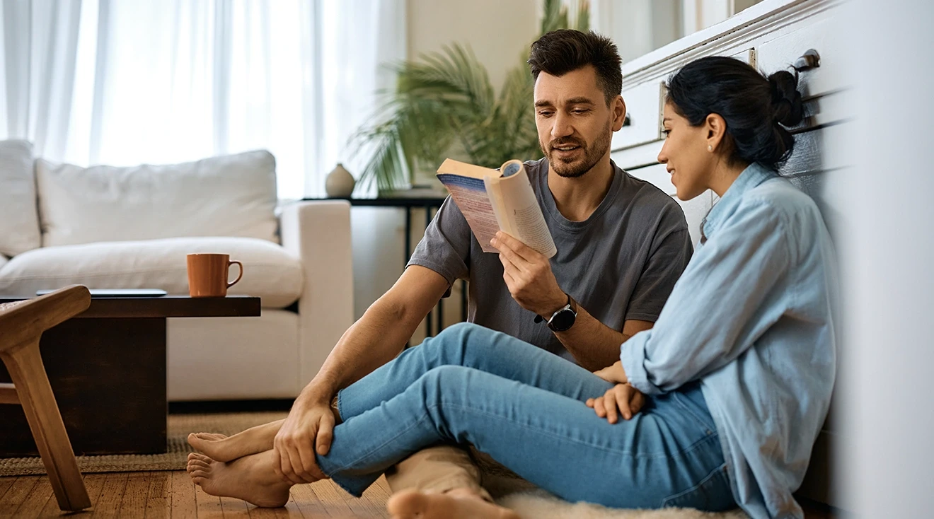 couple reading a parenting book at home