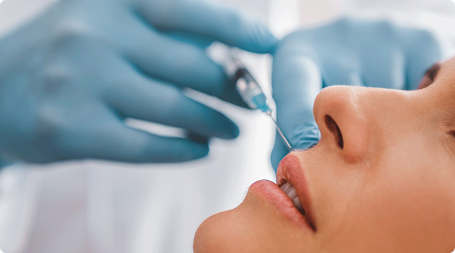 doctor injecting botox into woman's face