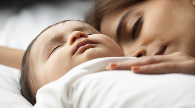 newborn baby sleeping with mom