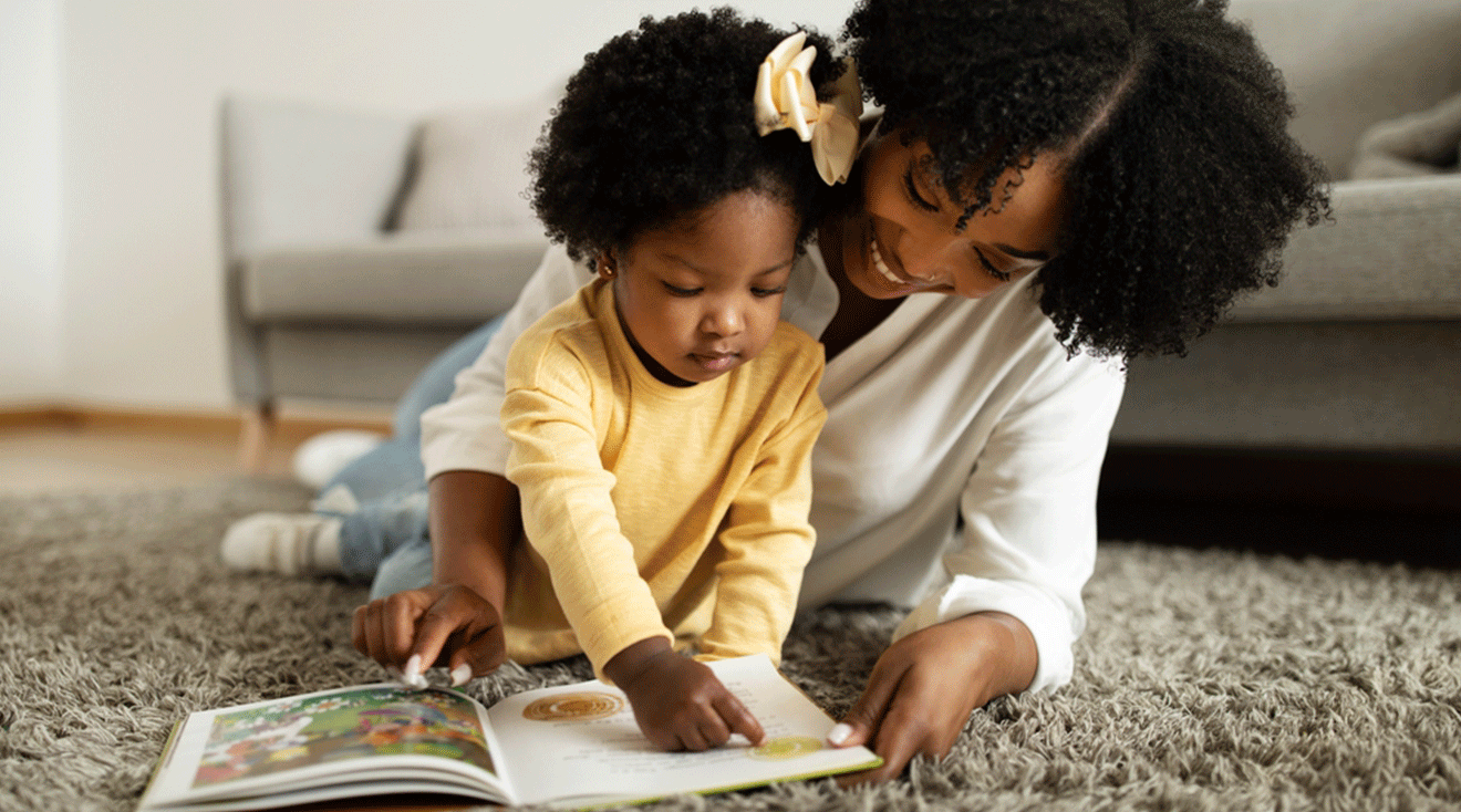 mom and toddler reading a book together