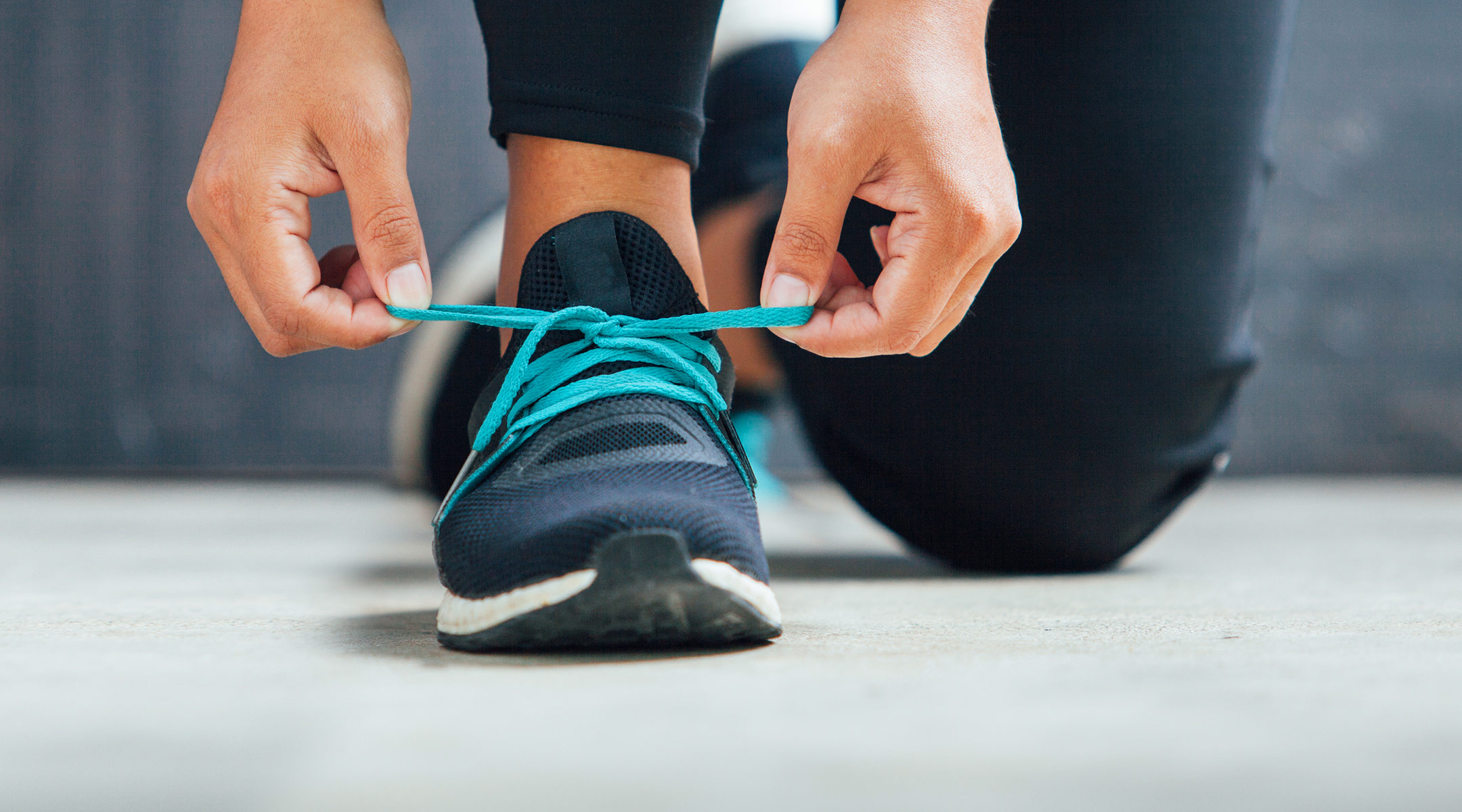 close up of woman tying her running sneakers