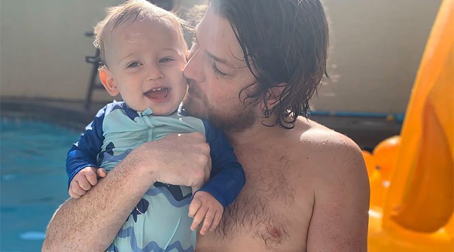 toddler boy with his dad in the pool