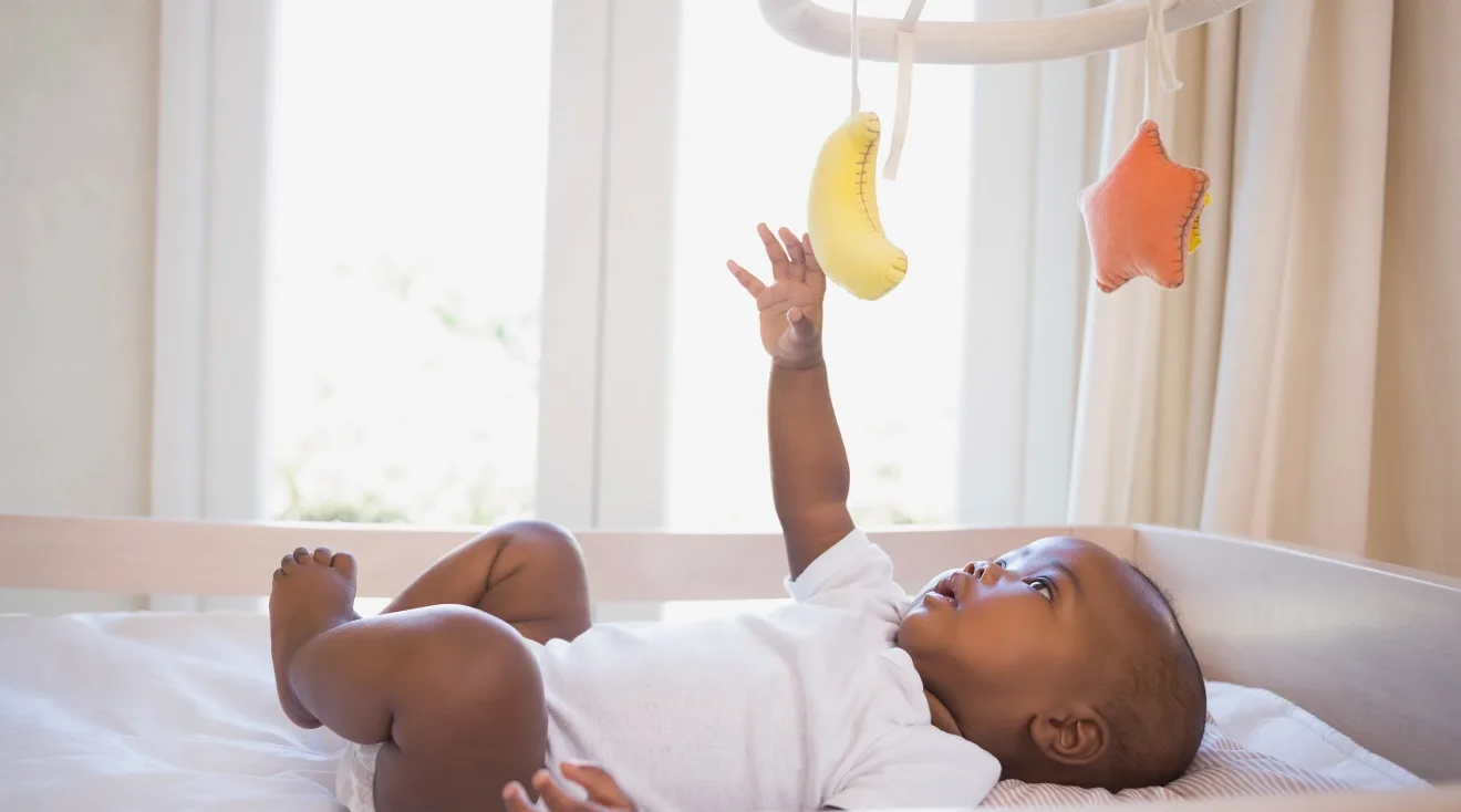 baby playing with mobile