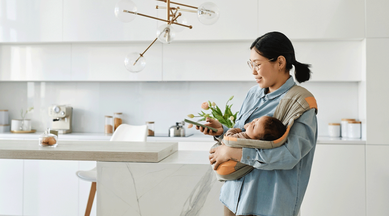 mom holding newborn baby at home