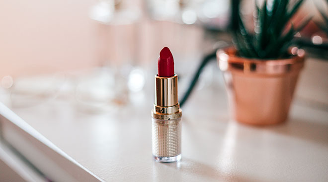 red lipstick on dresser in bedroom at home