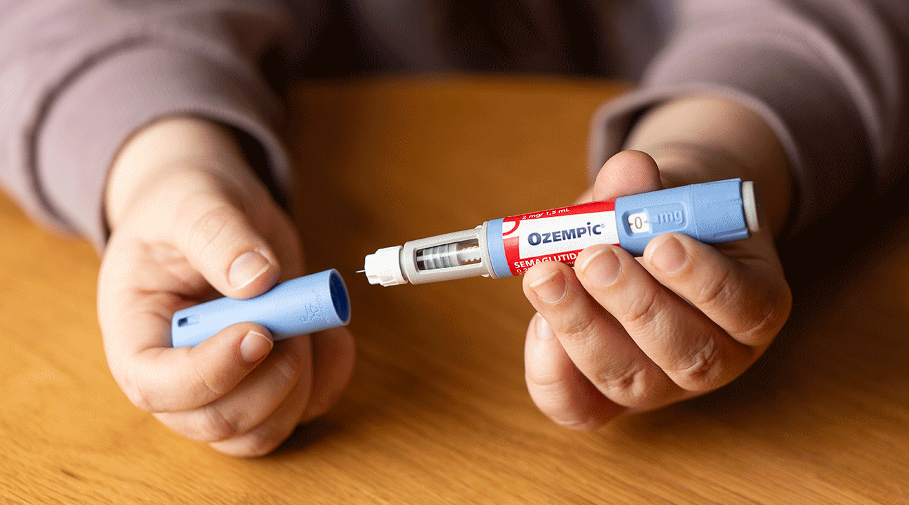 woman holding ozempic injection