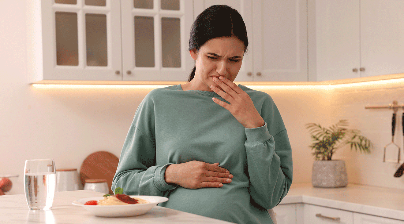 pregnant woman grossed out by food on table