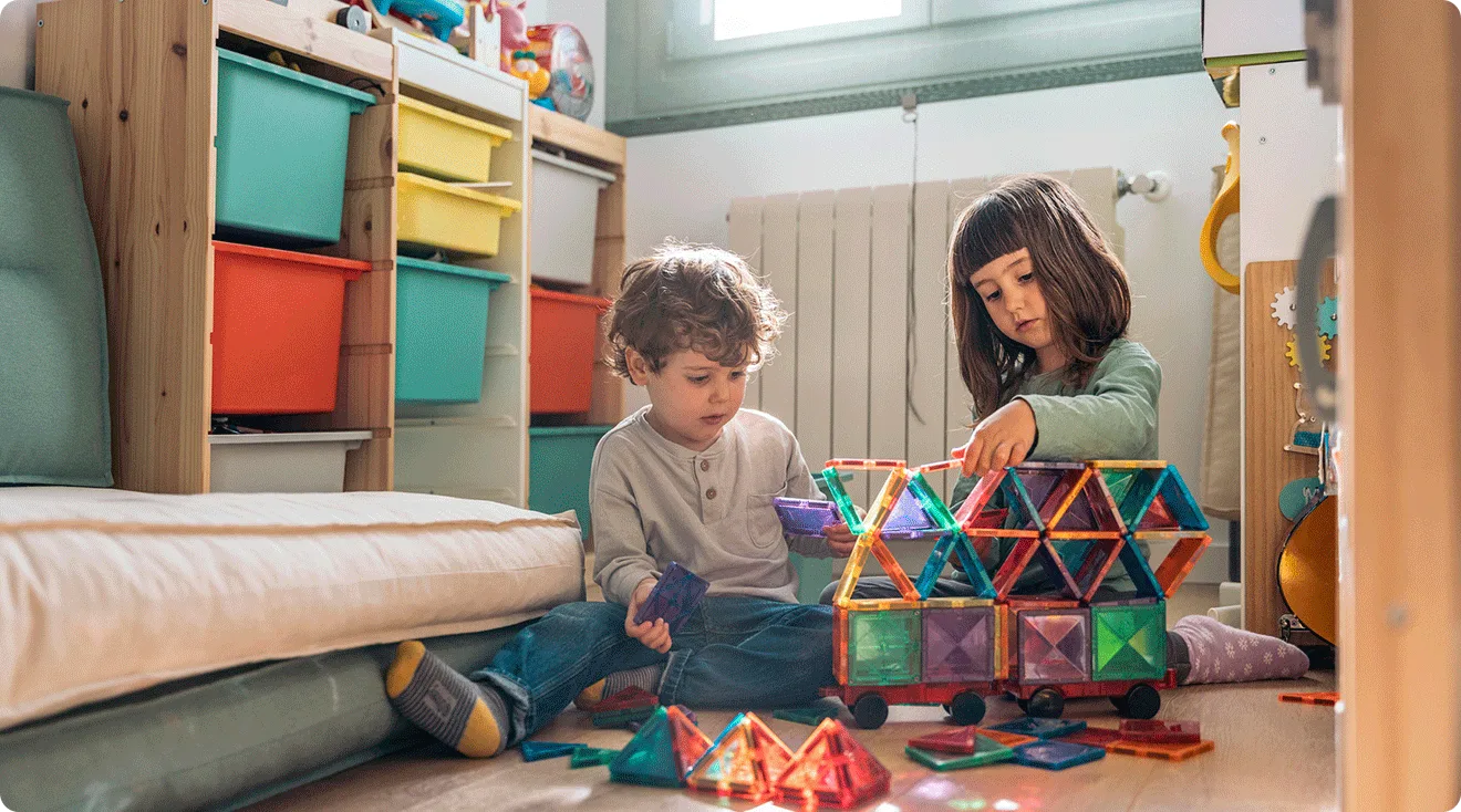 young children playing with rainbow magnetic tile toy