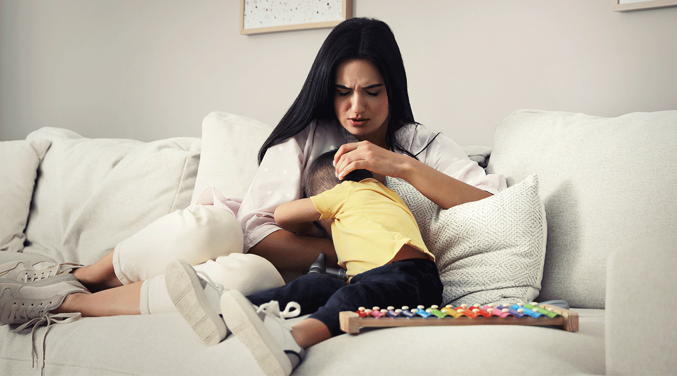 mom comforting toddler at home