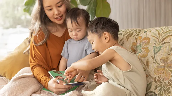 mother reading with her toddlers at home