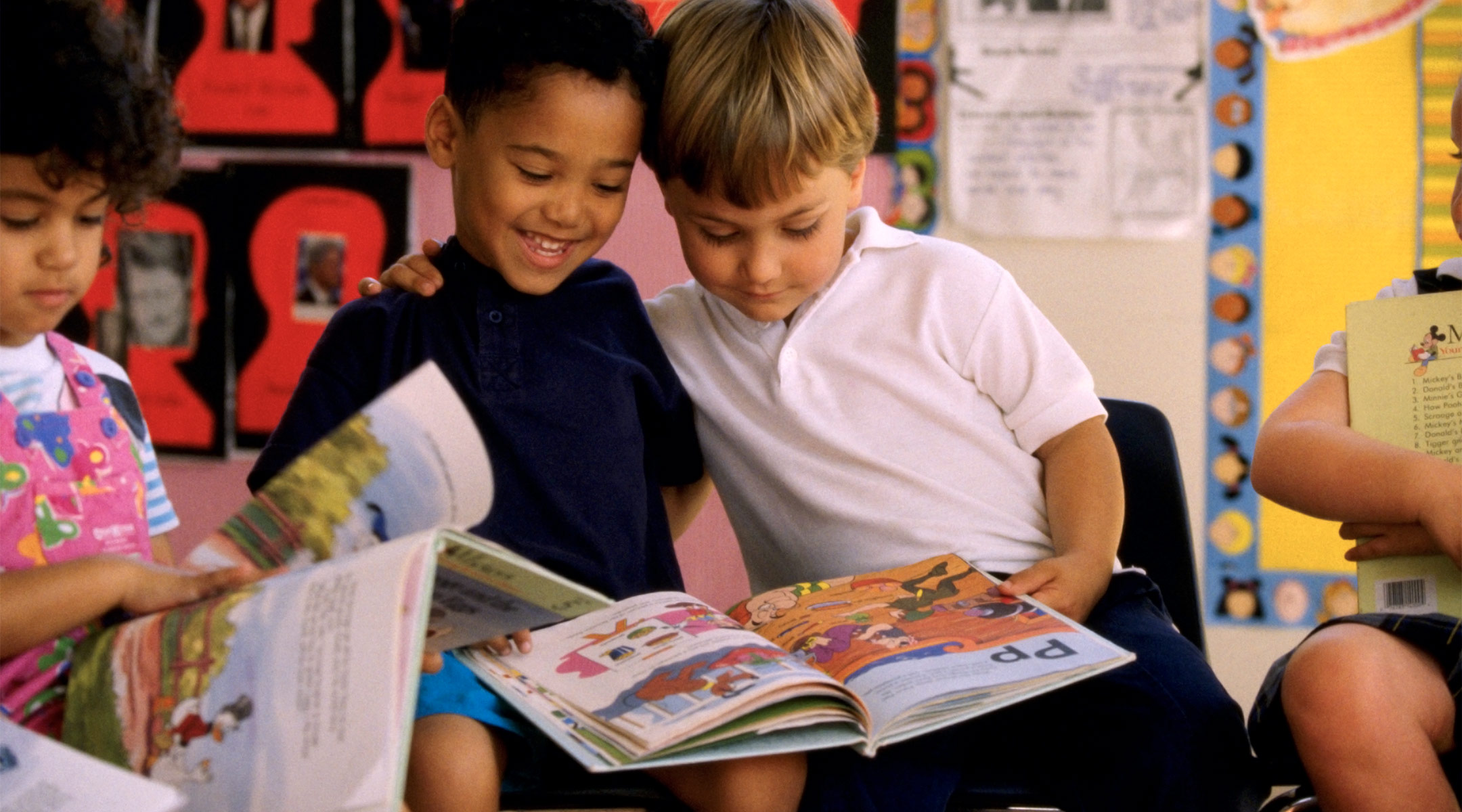 two little boys reading together in classroom