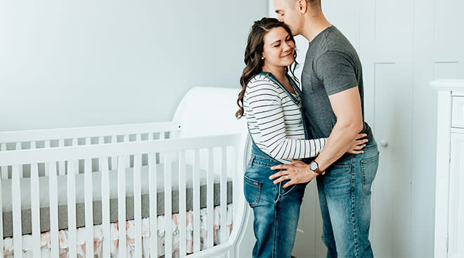 pregnant couple at home in their nursery