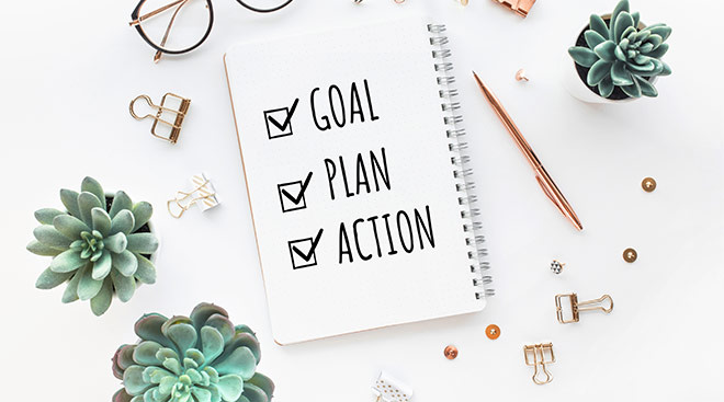 notebook that says goal, plan, action with check marks