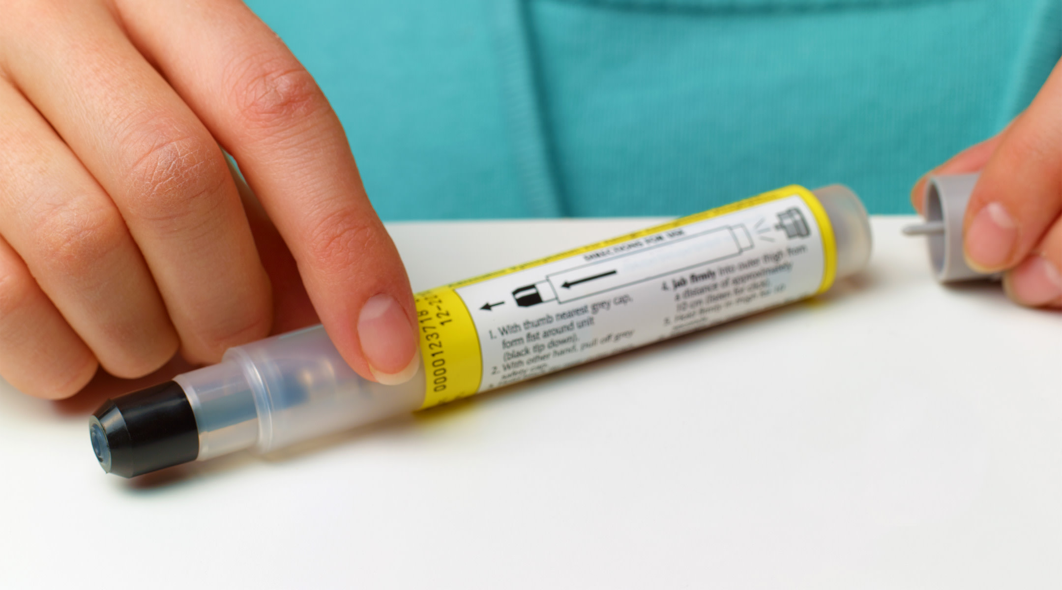 woman's hands opening epipen