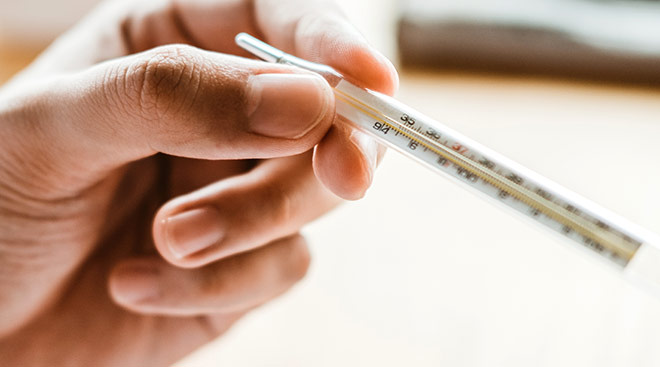 hand holding thermometer