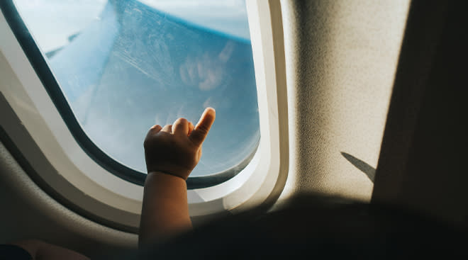baby's hand in airplane window