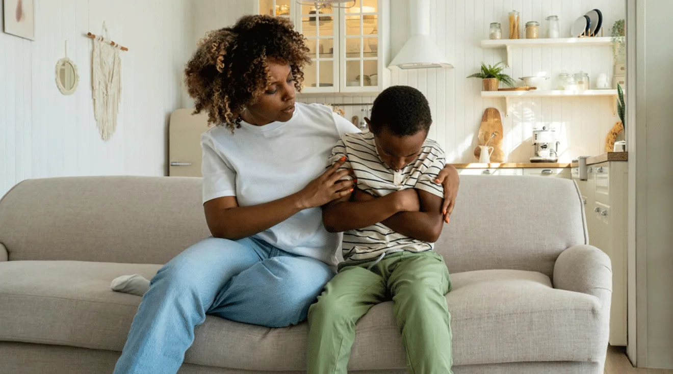 mom trying to comfort angry child at home