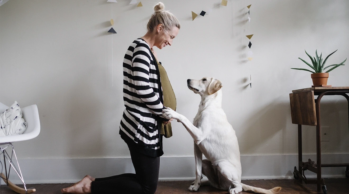 pregnant woman and her dog at home
