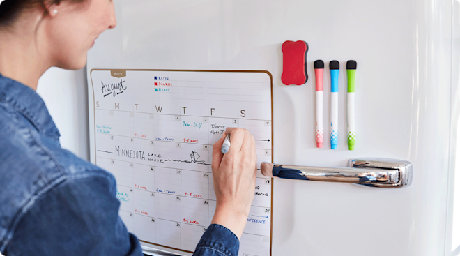 woman filling in calendar at home