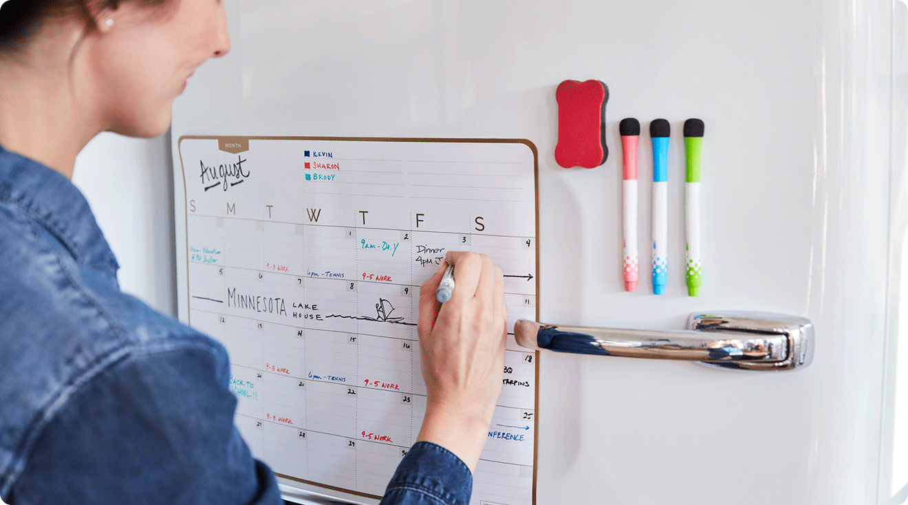 woman filling in calendar at home