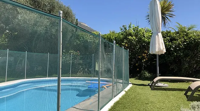 pool in backyard with safety fence