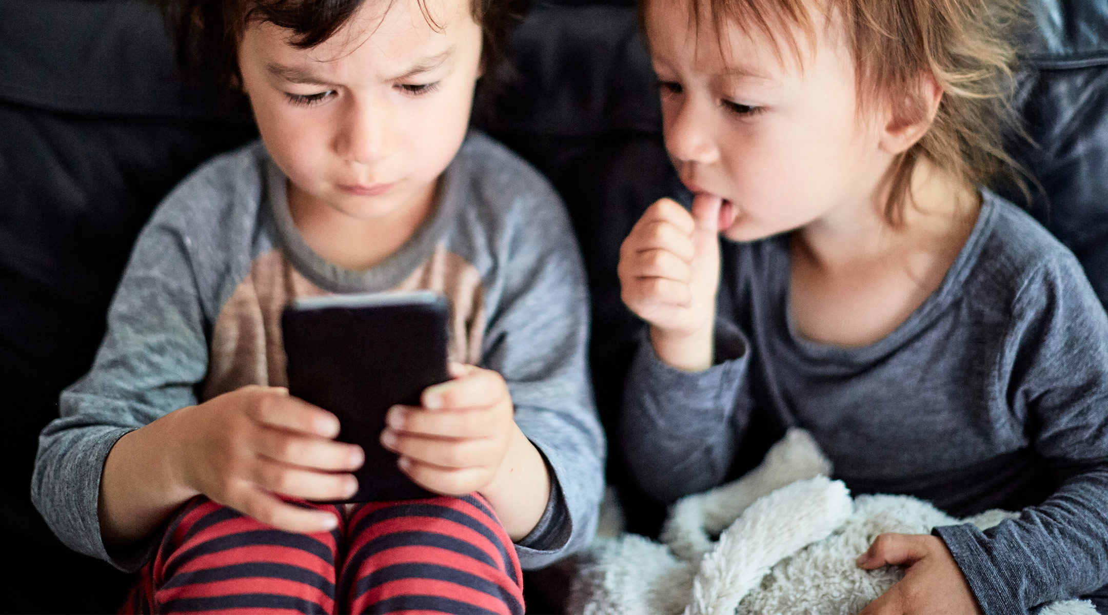 two little boy watching phone screen