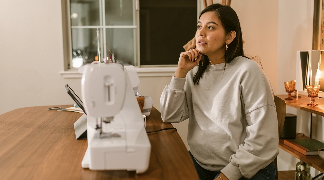 pregnant woman thinking at desk