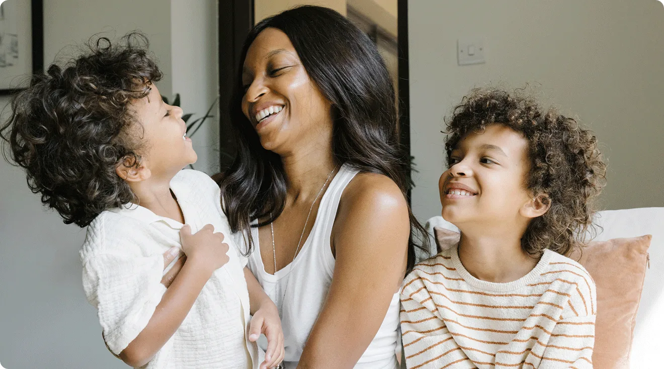 mom laughing with her two sons