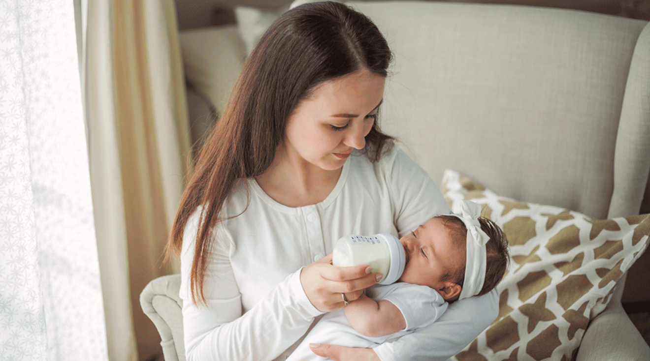 mother feeding a bottle to baby