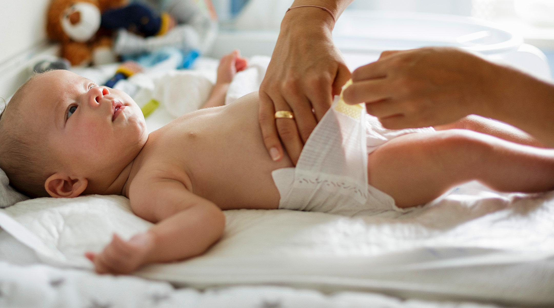 parent changing baby's diaper