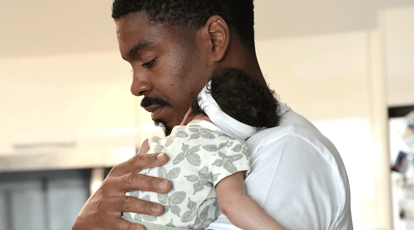 leroy garrett holding newborn baby