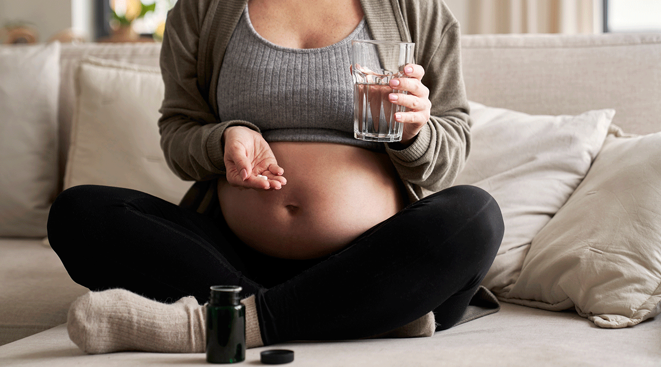 pregnant woman taking supplement