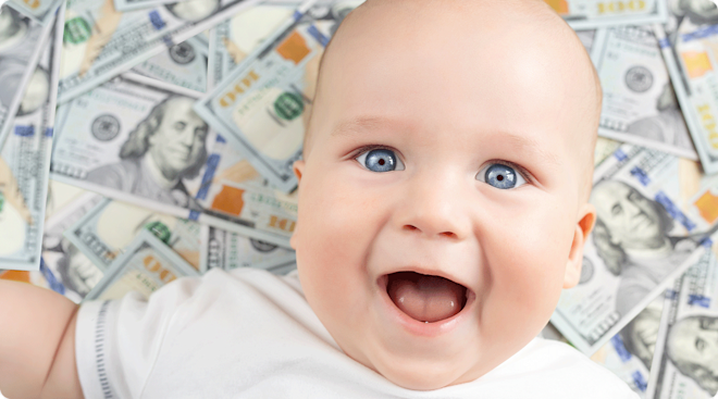 baby smiling with 100 dollar bills in the background