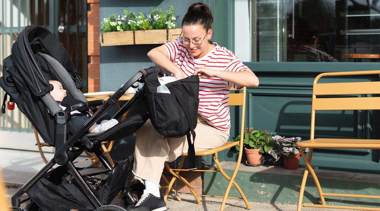 mom sitting at a cafe with baby stroller