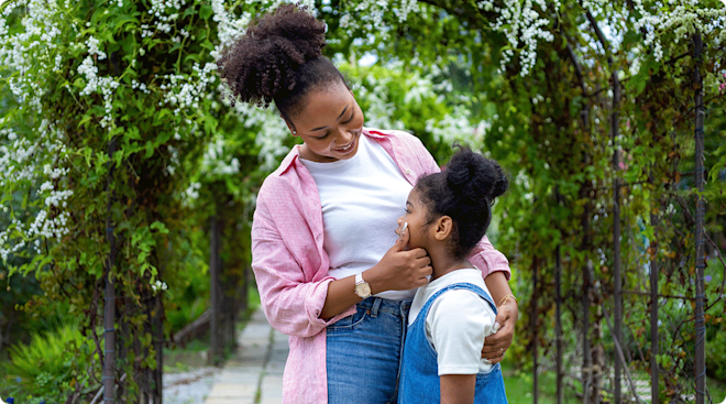 mother hugging young daughter