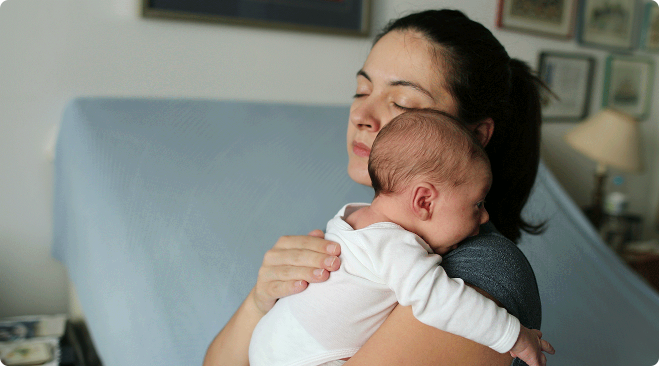 mom trying to soothe baby at home